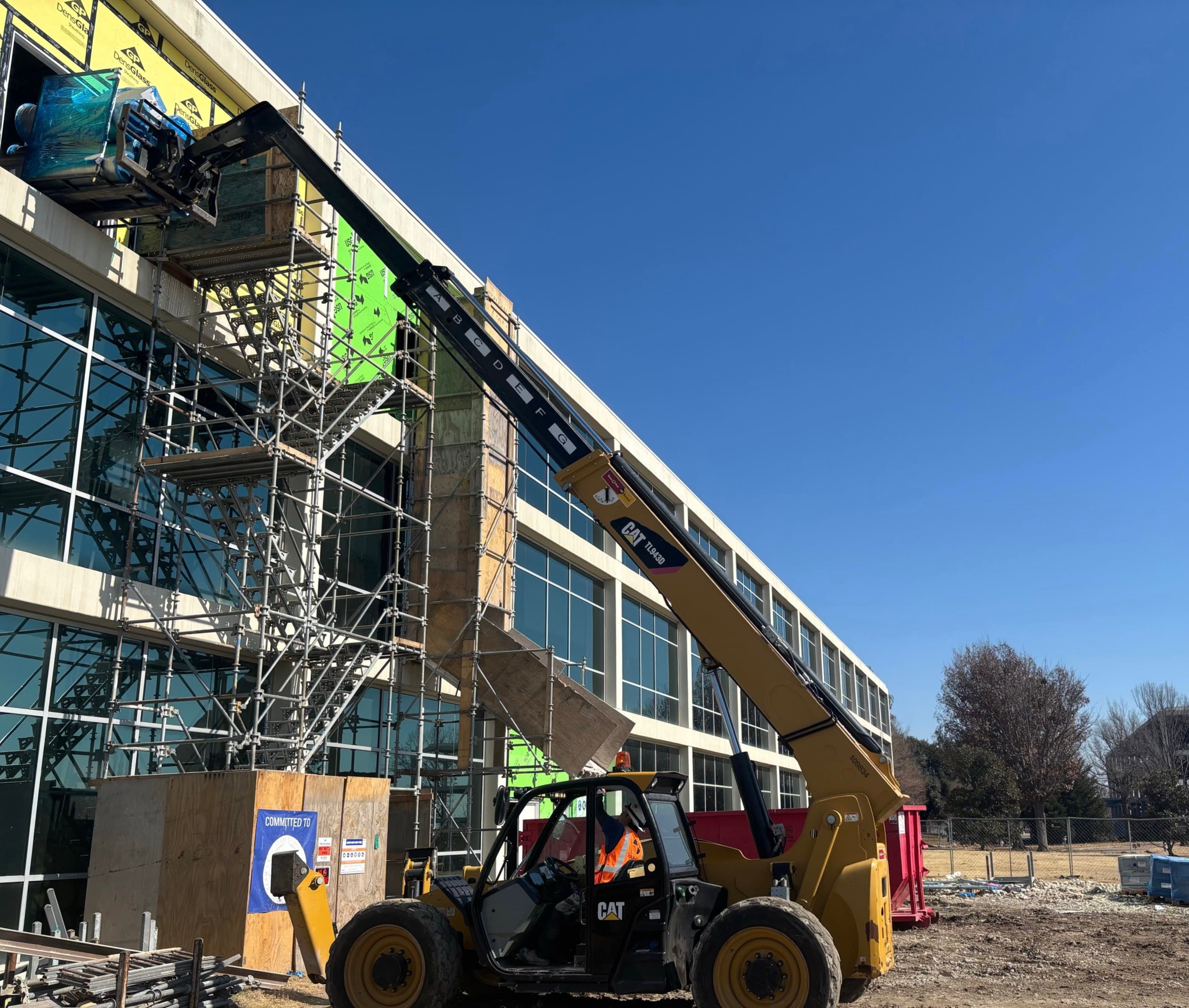 Telehandler lifting materials to the facade of the Celestica office building in Richardson, Texas, during construction